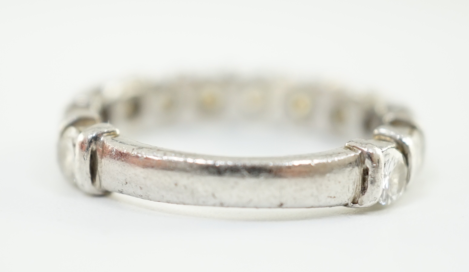 An 18ct white gold and thirteen stone round brilliant cut diamond set three quarter eternity ring